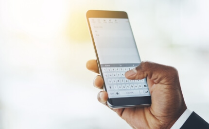 The hand of inputting text with a smartphone keyboard. A comfortable input experience utilizing