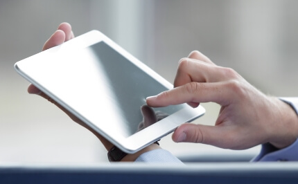 A hand to operate the tablet device. iWnn IME for Web, a Cloud-enabled text input service, provides a predictive conversion function for an industry-optimized input experience.