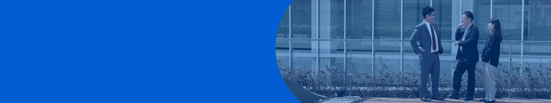 A visual accompanying a message from the hiring manager, showing employees in suits conversing on the terrace in front of the office